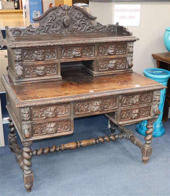 A late Victorian carved oak kneehole desk, W.120cm., D.74cm., H.131cm.